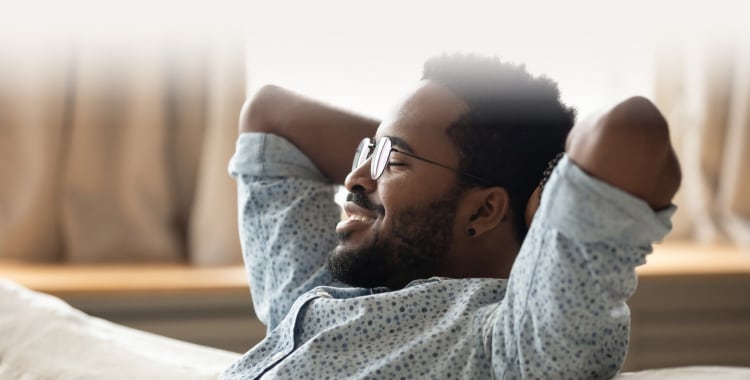 Man smiling and relaxing on a couch